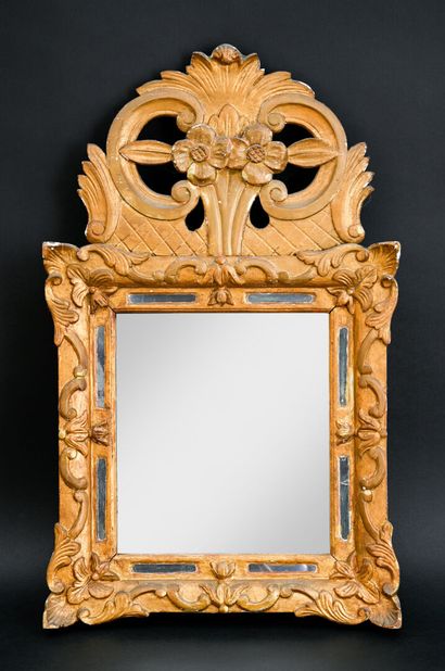 Small mirror in gilded wood and carved with...