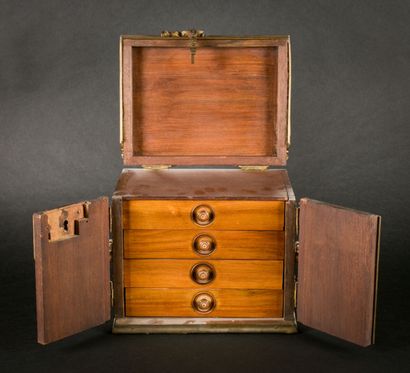 null Wood and bronze box opening with two doors and concealing four drawers.

H :...