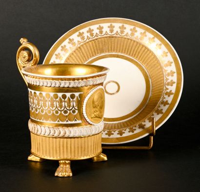 null 
Cup and saucer in white and gold porcelain decorated with a portrait of Louis...