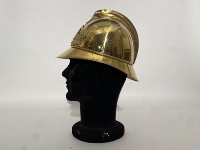 null Brass sheet firefighter's helmet with prominent crest. The front of the helmet...