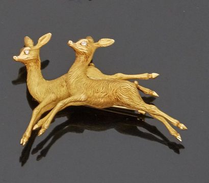 null Brooch featuring two 18 k (750 thousandths) yellow gold deer with eyes set with...
