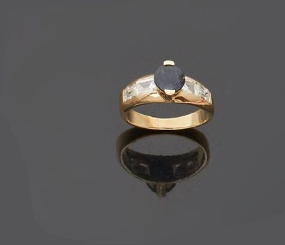 null 14 k (585 thousandths) yellow gold ring set with a round sapphire set with two...