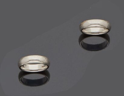 null Pair of platinum (900 mm) men's wedding rings in their original case located...