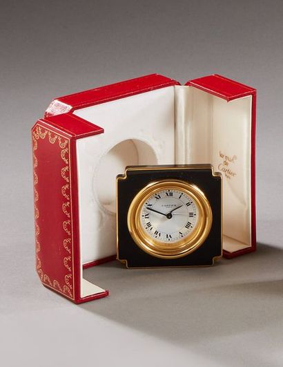 CARTIER 
Brass travel clock decorated with...