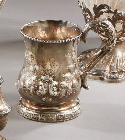 null Silver mug with a handle, decorated with a repoussé work decorated with flowered...