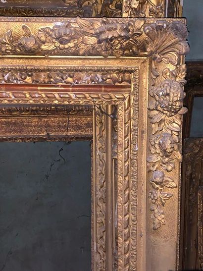 null Two gilded and carved wooden frames, one in the Louis XV style decorated with...