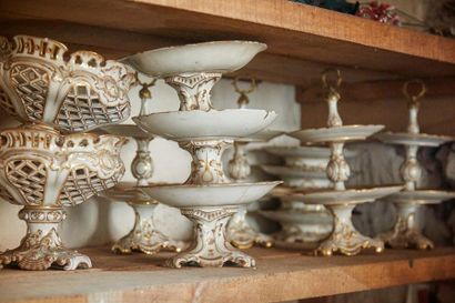 null White porcelain service part with gilded decoration of rocailles and foliage...