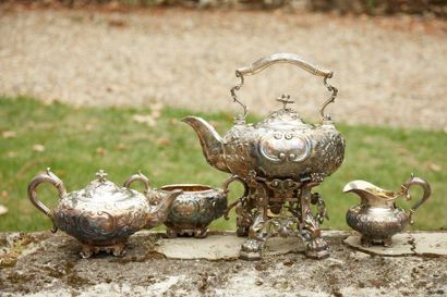 null LE COINTE - A silver tea service with rich repoussé decoration of foliage scrolls,...
