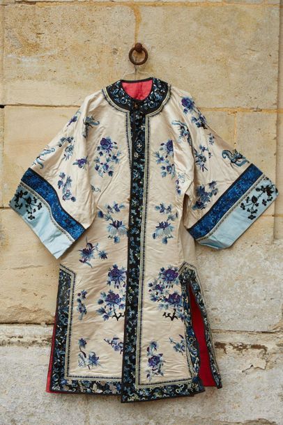 null White silk woman's kimono embroidered with blue peony bouquets.

China, circa...