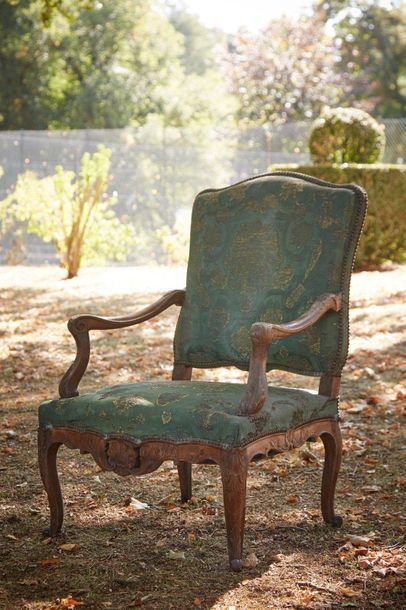 null Armchair with a flat back called "à la Reine" in natural wood molded and carved...