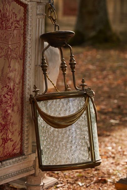 null Cylindrical bronze lantern with drapery decoration, flower buds, glass with...