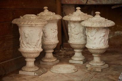 null Four garden vases in carved white marble with low relief decoration of putti...