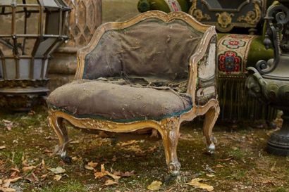 null Small low armchair in carved and gilded wood, arched legs finished with casters...