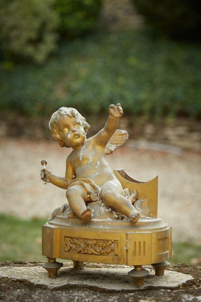 null Gilt bronze clock base depicting a Love sitting on clouds, rests on a base decorated...