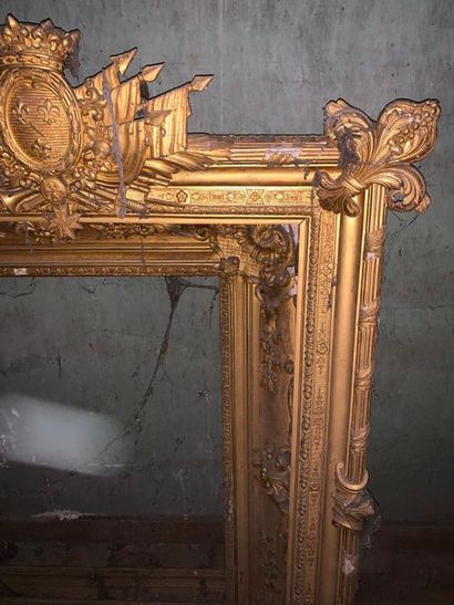 null Louis XIV style gilded wood and stucco frame decorated with a ribboned rush,...