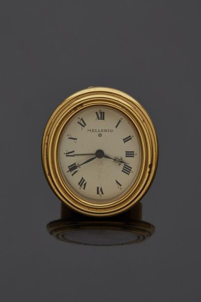 null Gilt bronze MELLERIO travel clock with oval dial and Roman numerals.

(Slight...