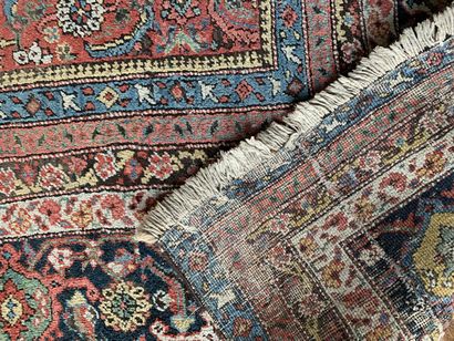 null 
Important oriental carpet with a red background decorated with a semi of stylized...