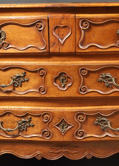 null Walnut chest of drawers, moulded and carved with a heart, a four-leaf clover,...
