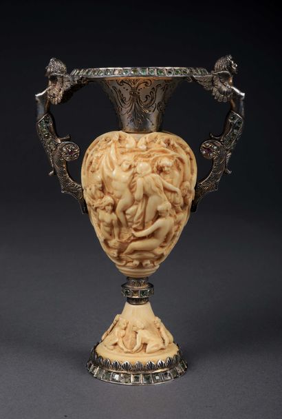 null 
An ivory baluster vase carved on all sides in low relief with a scene representing...