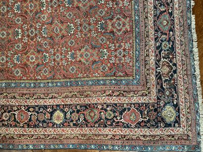 null 
Important oriental carpet with a red background decorated with a semi of stylized...