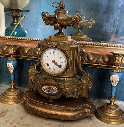 null Mantelpiece including a clock and two gilt bronze torches in the Louis XVI style...