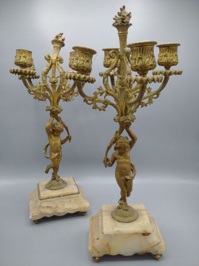 null Pair of bronze candelabra with four arms of light representing putti bearing...