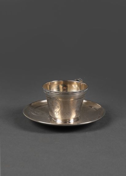 null Silver cup and saucer chased with a circular ring design with a sprinkling of...