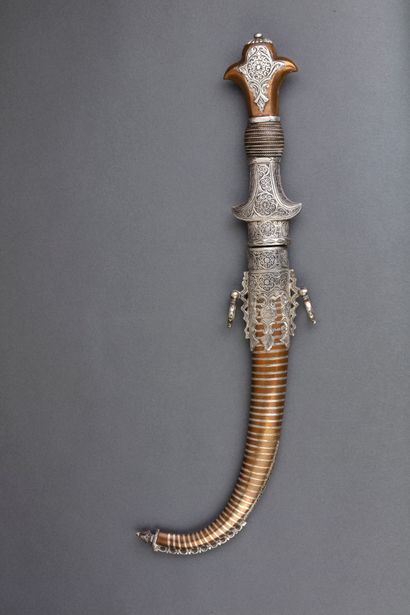 null Arabian dagger called Koumyah. 

Brass and silver plated handle with filigree...