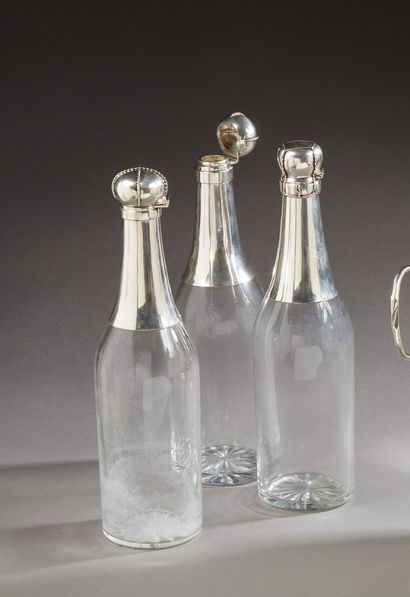 null Three bottle decanters, the body in cut crystal, the neck and the stopper in...
