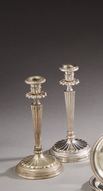 null Pair of silver candlesticks, conical fluted shaft, round base decorated with...