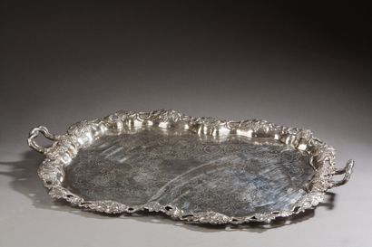 null A large silver platter with two handles, the edges decorated with openwork vine...