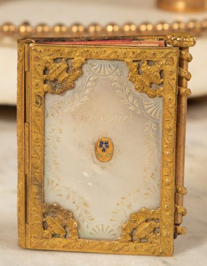null 
Gilded copper notebook decorated with floral motifs and two mother-of-pearl...
