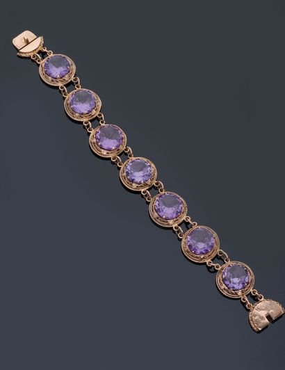  Bracelet en or jaune 14 k (585 millièmes) serti de pierres violettes. 
Travail étranger....