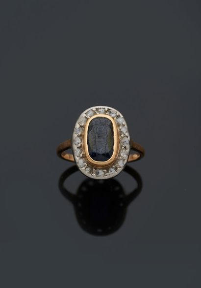null Yellow gold and 18 k (750 thousandths) white gold ring set with an oval sapphire...