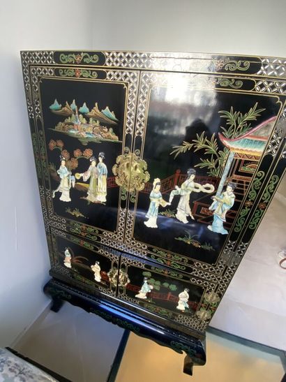 null 
Cabinet in the Chinese taste in black lacquered wood with relief decoration...