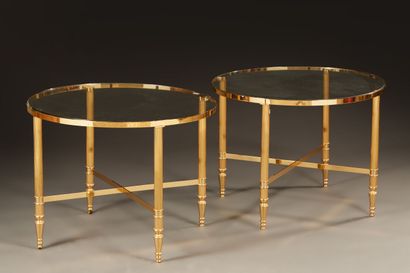 null Pair of circular coffee tables in gilded metal with glass top. Fluted uprights...
