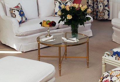 null Pair of circular coffee tables in gilded metal with glass top. Fluted uprights...