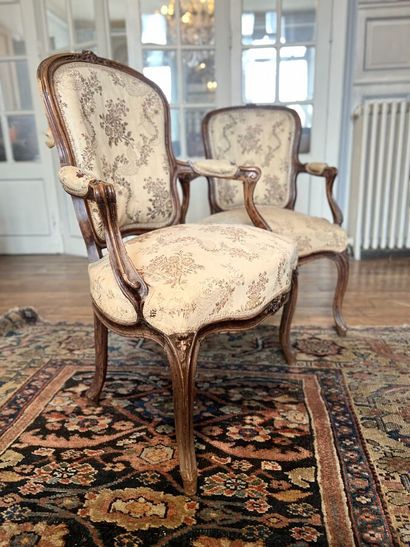 null Two small armchairs cabriolets in natural wood decorated with flowers and moldings,...