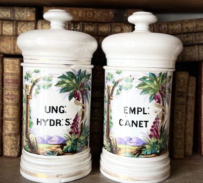 null Two Paris porcelain medicine jars with polychrome stamped decoration (restorations...