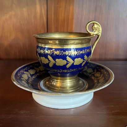 null Chocolate cup on pedestal and its saucer in porcelain with blue and gilded decoration...
