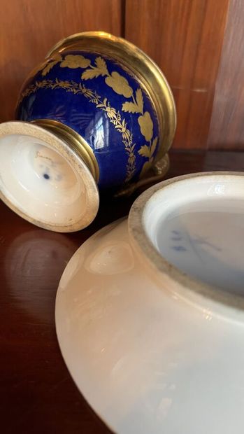 null Chocolate cup on pedestal and its saucer in porcelain with blue and gilded decoration...