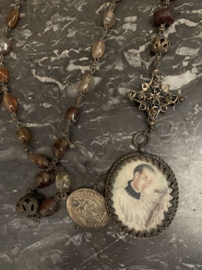 null Two antique rosaries including a metal rosary and amber beads ended by a reliquary...