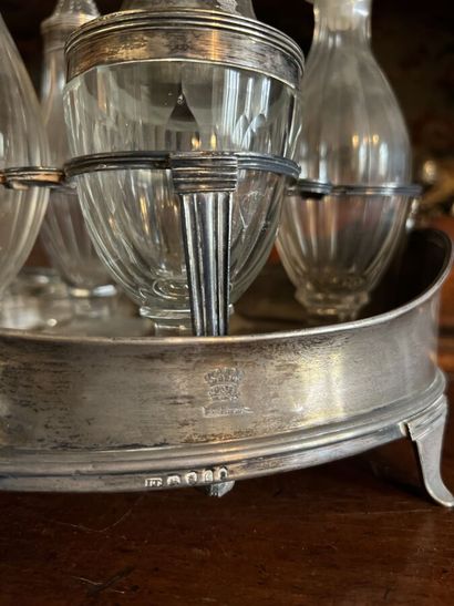 null English silver condiment set resting on four feet, engraved with a crest.
We...