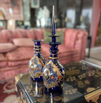 Two blue crystal decanters, with polychrome...