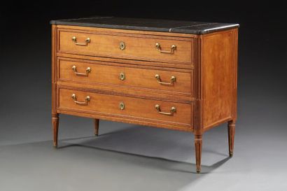 null Une commode de style Louis XVI en bois naturel, ouvrant par trois tiroirs encadrés...