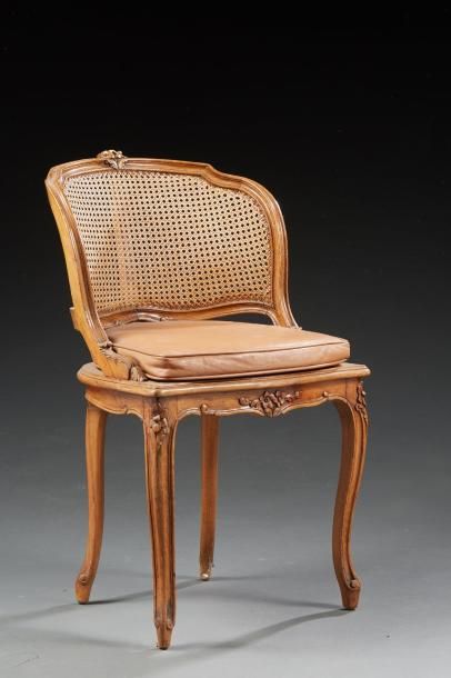 null Une chaise à coiffer de style Louis XV en bois naturel sculpté de fleurettes....