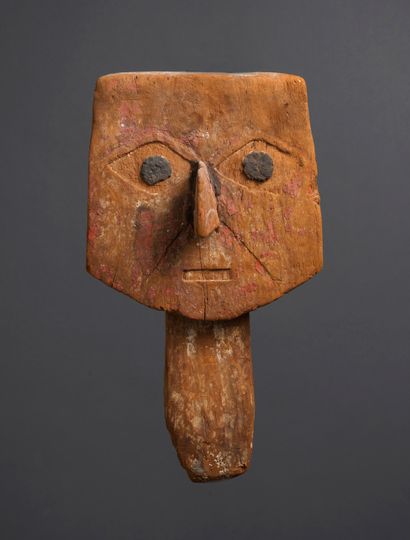 Mask representing a stylized human face 
The...