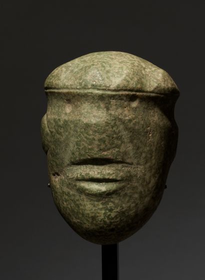Stylized head of character, 
adorned with...