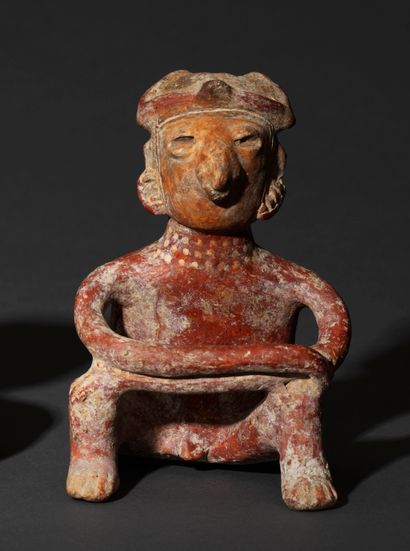 Seated figure 
Brown terracotta with red...