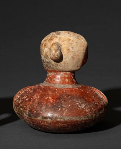 Globular vase decorated with a human face...